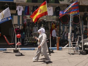 A sports supply shop displays flags of Spain in its window in the city centre of Hebron in the occupied West Bank on May 22, 2024.