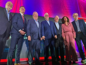 Former Quebec premier Philippe Couillard is joined on stage by former and current Quebec Liberal leaders Pierre Arcand, Marc Tanguay, Jean Charest, Daniel Johnson, Dominique Anglade and Jean-Marc Fournier.