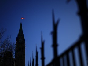 The Canada flag catches the morning light on the Peace Tower on Parliament Hill in Ottawa on Tuesday, April 16, 2024.