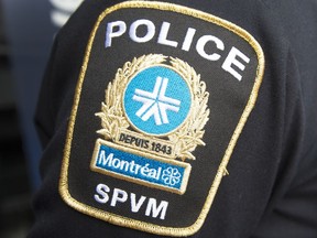 A police badge is seen on an arm.