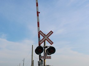 Lights and gate arm at a level crossing. The arm is up.