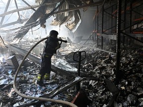 A Ukrainian rescuer works at the site of a missile attack in Kharkiv on May 23, 2024, amid the Russian invasion of Ukraine.