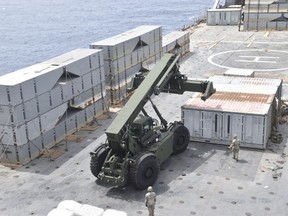 soldiers assigned to the 7th Transportation Brigade (Expeditionary) and sailors attached to the MV Roy P. Benavidez assemble the Roll-On, Roll-Off Distribution Facility (RRDF), or floating pier, off the shore of Gaza on April 26, 2024.