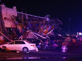 Several cars are seen heavily damaged outside the remains of a Shell gas station after a suspected tornado, Sunday, May 26, 2024, in Valley View, Texas.