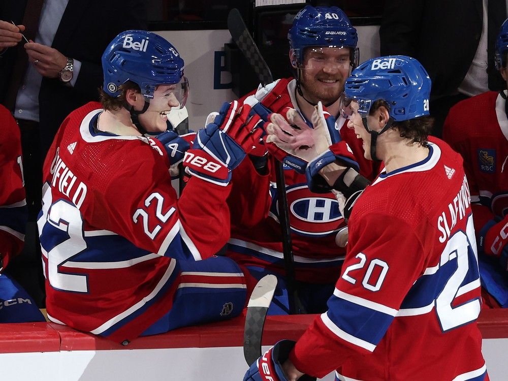 Canadiens' Juraj Slafkovsky celebrates a goal with teammates Cole Caufield, left, and Joel Armia during an April game at the Bell Centre. 