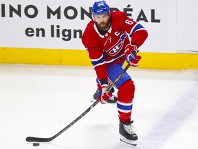 Shea Weber is seen skating past a blue line with the puck on his stick as he looks up to