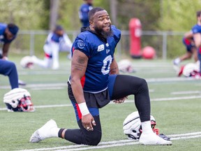 Defensive-lineman Shawn Lemon stretches during Alouettes training camp in St-Jérôme