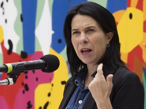 Valérie Plante speaks at a press conference with a colourful wall behind her.