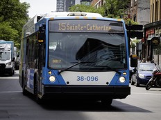 An STM bus marked 15 Sainte-Catherine on a downtown street
