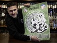 The Burgundy Lion co-owner Paul Desbaillets holds the pub's Euro poster on Monday, June 10, 2024.
