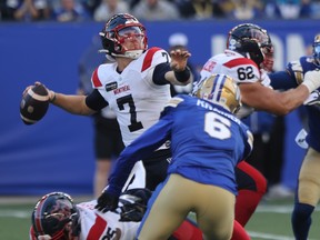 Alouettes' Cody Fajardo reaches back to throw a pass with the football during a game