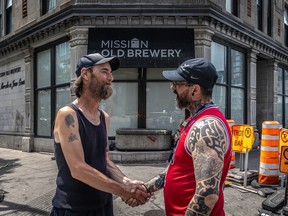 Intervention worker Dominic Bombardier, right, speaks with Ronald Bray, who is staying at the Old Brewery Mission, in Montreal on Wednesday June 19, 2024.