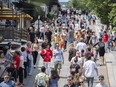 Tourists walk in a pedestrian-only zone in Old Montreal