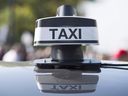 Taxis block a street during a demonstration against Uber's operations in Montreal on October 5, 2016.