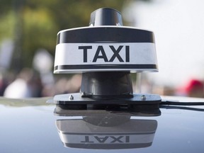 Taxi sign on top of a cab
