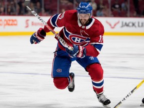 Torrey Mitchell is seen skating on Bell Centre ice sporting the Canadiens' traditional red jersey and blue hockey pants.