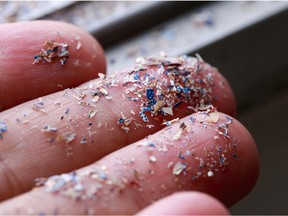 Close up side shot of microplastics lay on a person's hand
