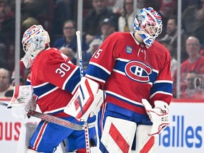 Canadiens goalie Sam Montembeault, right, is seen skating off the ice during a game at the Bell Centrem while his replacement, Cayden Primeau, is seen behind him to the left.