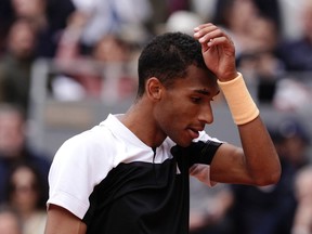 Felix Auger-Aliassime holds his head