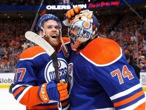 Oilers superstar Connor McDavid rubs the mask of goalie Stuart Skinner after the Oilers advanced to the Stanley Cup final Sunday night.