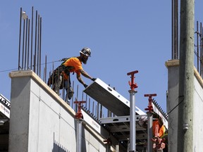 A construction worker on top of a building under construction
