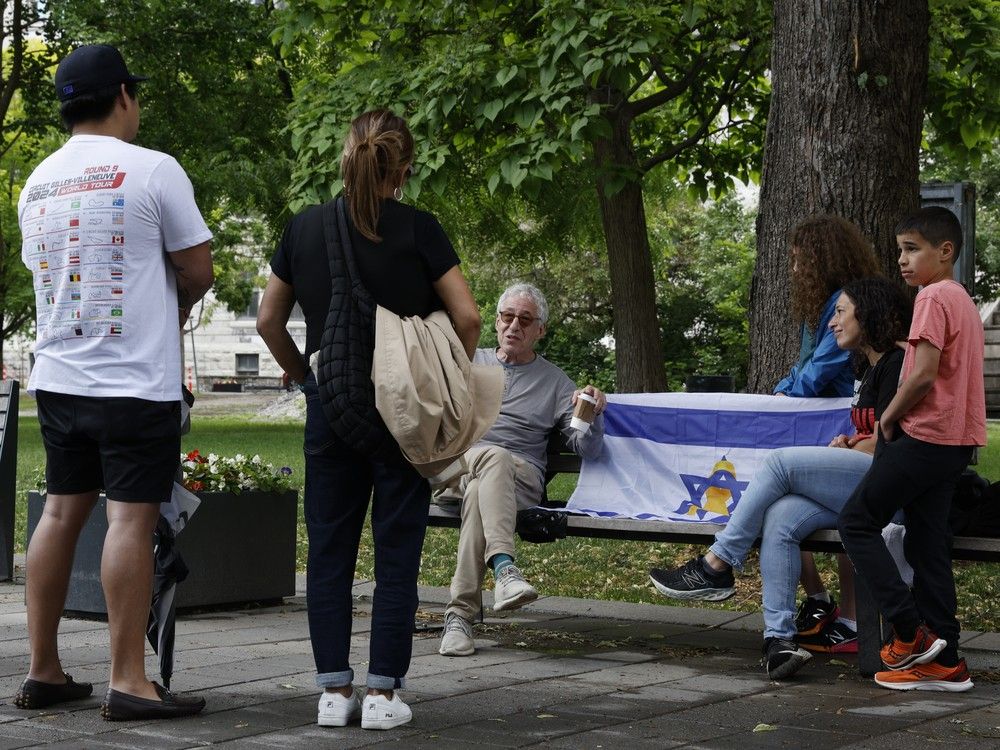 Dr. Gerald Batist, seated left, and colleague Dr. Karine Assouline regularly engage with passersby on the McGill campus to talk about the Israel-Hamas war, peace and justice.