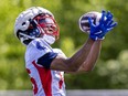 Receiver Charleston Rambo looks the ball into his hands while making a catch during Montreal Alouettes training camp practice in St-Jérôme.