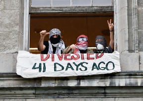Protesters in a window of the James Administration building at McGill University