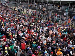Fans watch as drivers celebrate on the podium after the 2023 Formula One Grand Prix at Circuit Gilles-Villeneuve in Montreal, on June 18, 2023.
