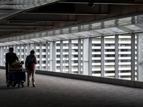 People make their way through Pearson Airport in Mississauga, Ont. on Tuesday, March 14, 2023.