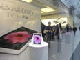 Customers are seen at an Apple Store in Toronto on Friday, March 16, 2012.