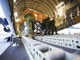 Royal Canadian Air Force personnel load non-lethal and lethal aid at CFB Trenton, Ontario, bound for Ukraine via Poland, Ontario on Monday, March 7, 2022.