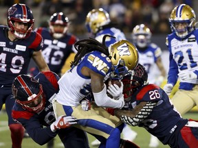 Alouettes linebacker Tyrice Beverette, right, slams into Bombers receiver Janarion Grant during last year's Grey Cup game.