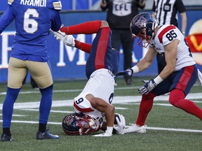 Alouettes receiver Tyson Philpot is seen flipped over with his head, arms and football in teh end zone and legs in the air after he was upended scoring a touchdown Thursday night in Winnipeg.