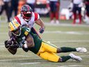 Alouettes' Darnell Sankey brings Elks' Hergy Mayala to the ground, one of eight tackles he recorded during Montreal's 23-20 win last week.  