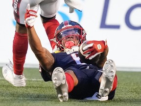 Alouettes receiver Tyson Philpot is seen on celebrating his back in teh end zone with his right arm in the air and left arm clutching the football after scoring a touchdown at Molson Stadium Thursday night.