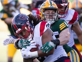Montreal Alouettes' Sean Thomas Erlington is tackled by Edmonton Elks' Michael Brodrique during first-half CFL action in Edmonton on Friday, June 14, 2024.