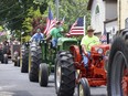 Children watch tractors in a parade in Waubeka, Wis., on June 9, 2024.