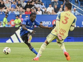 CF Montreal forward Kwadwo Opoku (7) scores against the New York Red Bulls as Red Bulls defender Noah Eile (3) looks on during first half MLS soccer action in Montreal, Wednesday, June 19, 2024.