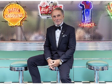 A man in a tux sitting at the counter of a '50s-style diner