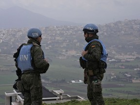 Spanish UN peacekeepers stand on a hill overlooking the Lebanese border villages with Israel in Marjayoun town on Wednesday, Jan. 10, 2024.