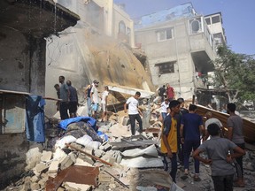 People search for survivors in the rubble of a building following Israeli bombardment at al-Bureij refugee camp in the central Gaza Strip on June 15, 2024.