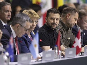 Ukrainian President Volodymyr Zelenskyy, centre, attends the plenary session during the Summit on peace in Ukraine, in Obbürgen, Switzerland, Sunday, June 16, 2024.