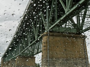 The Jacques Cartier Bridge seen through the rain drops on the windshield of a car.