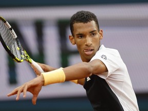 Félix Auger-Aliassime plays a shot against Ben Shelton of the U.S. during their third round match of the French Open tennis tournament at the Roland Garros stadium in Paris, Saturday, June 1, 2024.