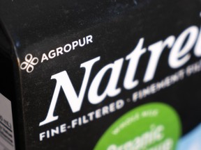 A milk carton with Natrel branding has the word AGROPUR in the corner
