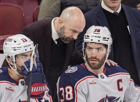 Columbus Blue Jackets head coach Pascal Vincent speaks with team captain Boone Jenner during first period of NHL game against the Canadiens in Montreal in March. Johnny Gaudreau is at left. Vincent is coming back to Quebec to coach the Laval Rocket.