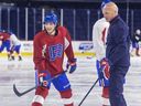 Canadiens prospect David Reinbacher was all smiles while listening to assistant coach Kelly Buchberger during Rocket practice in March. Expect Reinbacher to start next season in Laval, Stu Cowan writes.