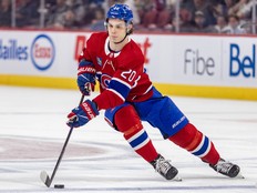 An action shot of Juraj Slafkovsky skating at the Bell Centre with the puck on his stick.