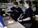 Alexandru Ionescu prepares a grilled cheese sandwich as Lindsay Oksenberg, right, and assistant job coach Elana Warshawsky look on at Pigeon dans le Parc in Hampstead Park on Tuesday, July 2, 2024.